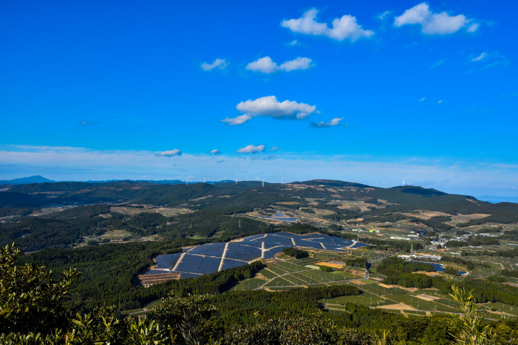 大野岳山頂から、鹿児島市方面を望む。再生可能エネルギーと言われるソーラーパネルや風力発電が目立つ。